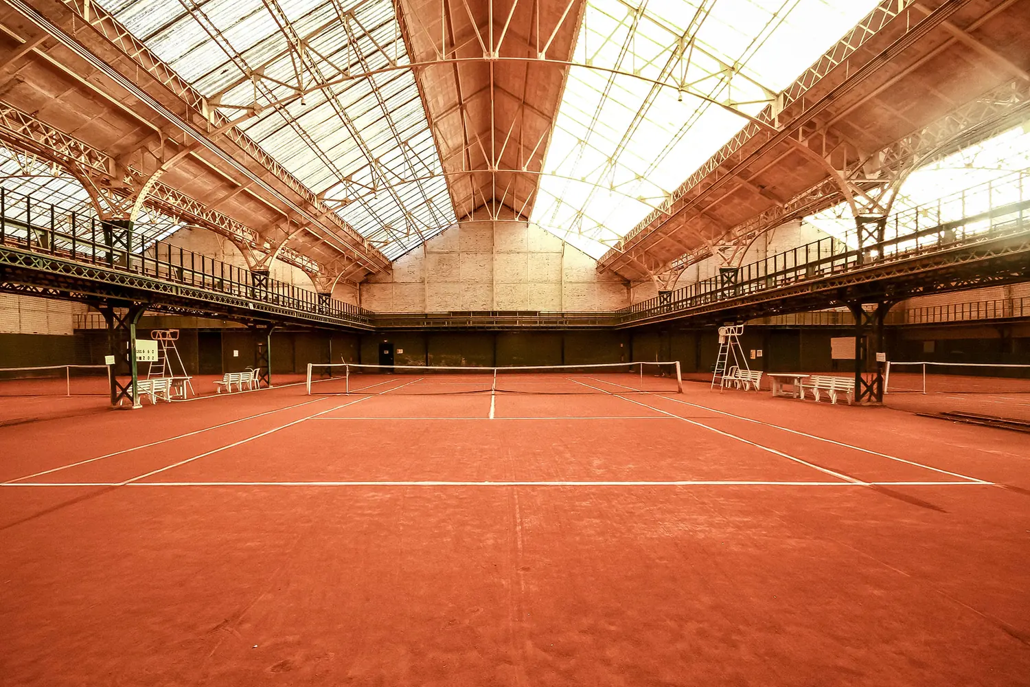 Vue au ras du sol du court central du Tennis Club des Flandres, charpente métallique en éventail au-dessus